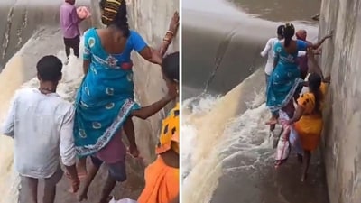 The image shows a man crossing a raging stream while carrying a pregnant woman on his shoulders. (X/@PavanJourno) The image shows a man crossing a raging stream while carrying a pregnant woman on his shoulders. (X/@PavanJourno)