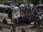 People stranded at the Tribhuwan Highway look on as rescue personnel work to retrieve the bodies of the victims from a landslide triggered by heavy rainfall in Dhading, Nepal, September 29, 2024. 