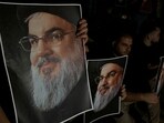 Supporters of Lebanon's Hezbollah leader Sayyed Hassan Nasrallah carry his pictures as they gather in Sidon, following his killing. 
