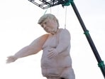 A 43-foot-tall (13 meters) naked statue resembling former US President and Republican presidential candidate Donald Trump is displayed in a fenced-in lot near Interstate 15 north of Las Vegas, Nevada, September 28, 2024. Made of foam over rebar and weighing approximately 6,000 pounds (2722 kilos), the gigantic display will will criss-cross the US as part of the "Crooked and Obscene Tour." 