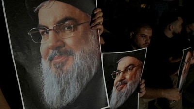 Supporters of Lebanon's Hezbollah leader Sayyed Hassan Nasrallah carry his pictures as they gather in Sidon, following his killing. (REUTERS)