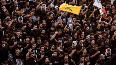 People hold pictures of Lebanon's Hezbollah Chief Hassan Nasrallah who was killed by an Israeli airstrike in Beirut, during a symbolic funeral in Baghdad, Iraq, September 29, 2024. REUTERS/Thaier al-Sudani (REUTERS)
