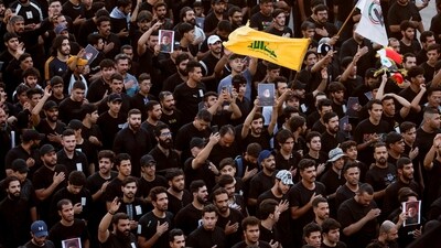 People hold pictures of Lebanon's Hezbollah Chief Hassan Nasrallah who was killed by an Israeli airstrike in Beirut, during a symbolic funeral in Baghdad, Iraq, September 29, 2024. REUTERS/Thaier al-Sudani (REUTERS)