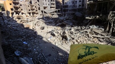 AHezbollah flag flies amid of the rubble of buildings which were levelled on September 27 by Israeli strikes that targeted and killed Hezbollah leader Hassan Nasrallah in the Haret Hreik neighbourhood of Beirut's southern suburbs. (AFP) AHezbollah flag flies amid of the rubble of buildings which were levelled on September 27 by Israeli strikes that targeted and killed Hezbollah leader Hassan Nasrallah in the Haret Hreik neighbourhood of Beirut's southern suburbs. (AFP)