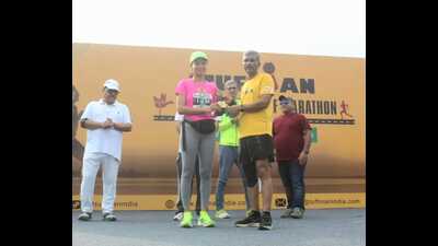 Lt General Manoj Kumar Katiyar giving away awards to winners of the Tuffman Chandigarh Half Marathon on Sunday. (HT Photo)