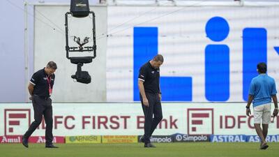 Match officials inspect the outfield at Green Park on Sunday. (PTI) Match officials inspect the outfield at Green Park on Sunday. (PTI)