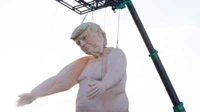 A 43-foot-tall (13 meters) naked statue resembling former US President and Republican presidential candidate Donald Trump is displayed in a fenced-in lot near Interstate 15 north of Las Vegas, Nevada, September 28, 2024. Made of foam over rebar and weighing approximately 6,000 pounds (2722 kilos), the gigantic display will will criss-cross the US as part of the "Crooked and Obscene Tour." (AFP)