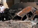 A man walks on rubble at the site of an Israeli airstrike in Beirut's southern suburbs. A man walks on rubble at the site of an Israeli airstrike in Beirut's southern suburbs.