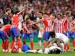 Real Madrid's French midfielder #14 Aurelien Tchouameni and Atletico Madrid's Spanish defender #24 Robin Le Normand lie on the ground during the Spanish league football match between Club Atletico de Madrid and Real Madri