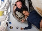 (FILES) This undated handout picture from Nasa released on July 2, 2024 shows NASA�s Boeing Crew Flight Test astronauts (from top) Butch Wilmore and Suni Williams inside the vestibule between the forward port on the International Space Station�s Harmony module and Boeing's Starliner spacecraft.