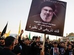 A person holds a poster of Lebanon's Hezbollah Chief Hassan Nasrallah who was killed by an Israeli airstrike in Beirut