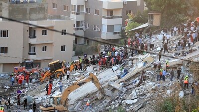 People and rescue teams search for victims after an Israeli airstrike hit two adjacent buildings, in Ain el-Delb neighbourhood east of the southern port city of Sidon, Lebanon, Sunday, Sept. 29, 2024. (AP/PTI)(AP09_30_2024_000012B) (AP) People and rescue teams search for victims after an Israeli airstrike hit two adjacent buildings, in Ain el-Delb neighbourhood east of the southern port city of Sidon, Lebanon, Sunday, Sept. 29, 2024. (AP/PTI)(AP09_30_2024_000012B) (AP)