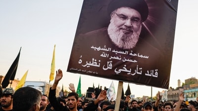 A person holds a poster of Lebanon's Hezbollah Chief Hassan Nasrallah who was killed by an Israeli airstrike in Beirut (REUTERS)