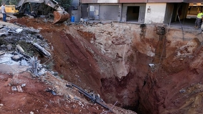 A hole in the ground near the site of the assassination of Hezbollah leader Hassan Nasrallah in Beirut's southern suburbs. Following the assassination of Hezbollah leader Hassan Nasrallah, oil prices increased amid rising Middle East tensions. Brent crude rose above $72, while Israel targeted locations in Lebanon and Yemen. Iran's response has been measured, as President Pezeshkian avoided direct threats against Israel. (AP)