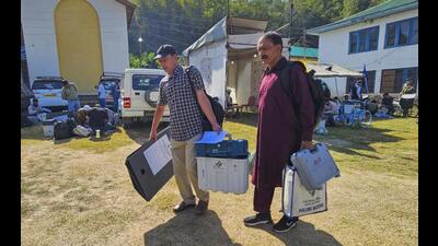 Polling officials carrying EVMs and other election material leave for their respecting polling booths from a distribution centre, ahead of voting in the third and last phase of Jammu and Kashmir assembly elections, in Baramulla district on Monday. (PTI Photo) Polling officials carrying EVMs and other election material leave for their respecting polling booths from a distribution centre, ahead of voting in the third and last phase of Jammu and Kashmir assembly elections, in Baramulla district on Monday. (PTI Photo)