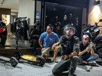 Israeli police and border police take cover during sirens, after Iran fired a salvo of ballistic missiles at Israel, and near the site of a fatal shooting attack in Jaffa, Israel.
