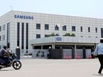Samsung plant protests: A motorcyclist rides past Samsung company plant in Sriperumbudur, on the outskirts of Chennai. Samsung plant protests: A motorcyclist rides past Samsung company plant in Sriperumbudur, on the outskirts of Chennai.