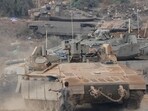 Israeli armored personnel carriers and tanks maneuver in a staging area in northern Israel near the Israel-Lebanon border. Israeli armored personnel carriers and tanks maneuver in a staging area in northern Israel near the Israel-Lebanon border.