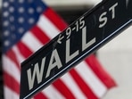 A Wall Street street sign in front of the New York Stock Exchange (NYSE) in New York, US. A Wall Street street sign in front of the New York Stock Exchange (NYSE) in New York, US.