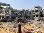 A woman looks around as she salvages items at the damaged UN Relief and Works Agency for Palestine Refugees building complex in western Gaza City's Al-Sinaa. A woman looks around as she salvages items at the damaged UN Relief and Works Agency for Palestine Refugees building complex in western Gaza City's Al-Sinaa.