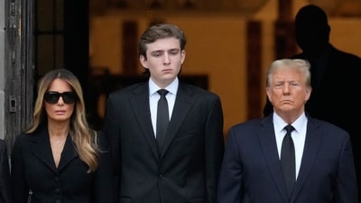 Former President Donald Trump, center right, stands with his wife Melania, second left, their son Barron, center left, as the coffin carrying the remains of Amalija Knavs, the former first lady's mother, is carried into the Church of Bethesda-by-the-Sea for her funeral, Thursday, Jan. 18, 2024, in Palm Beach, Fla. (AP Photo/Rebecca Blackwell) (AP) Former President Donald Trump, center right, stands with his wife Melania, second left, their son Barron, center left, as the coffin carrying the remains of Amalija Knavs, the former first lady's mother, is carried into the Church of Bethesda-by-the-Sea for her funeral, Thursday, Jan. 18, 2024, in Palm Beach, Fla. (AP Photo/Rebecca Blackwell) (AP)