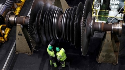 A worker inspects the offline turbine hall of Ratcliffe on Soar Coal-fired power station in Nottinghamshire central England on October 1, 2024. The UK�s last coal-fired power station shut down on September 30 after 60 years of looming over the small town of the same name, the closure signalled the end to polluting coal-powered electricity in the UK, in a landmark first for any G7 nation. (Photo by Darren Staples / AFP) (AFP) A worker inspects the offline turbine hall of Ratcliffe on Soar Coal-fired power station in Nottinghamshire central England on October 1, 2024. The UK�s last coal-fired power station shut down on September 30 after 60 years of looming over the small town of the same name, the closure signalled the end to polluting coal-powered electricity in the UK, in a landmark first for any G7 nation. (Photo by Darren Staples / AFP) (AFP)