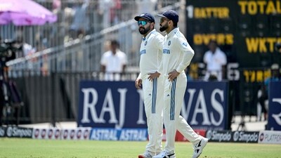 India's Virat Kohli (R) and captain Rohit Sharma arrive to field during the second Test cricket match between India and Bangladesh (AFP)