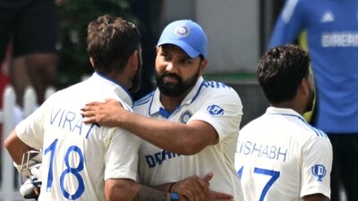 India's captain Rohit Sharma (C) embraces his teammate Virat Kohli (L) after winning the fifth and final day of the second Test cricket match between India and Bangladesh (AFP) India's captain Rohit Sharma (C) embraces his teammate Virat Kohli (L) after winning the fifth and final day of the second Test cricket match between India and Bangladesh (AFP)