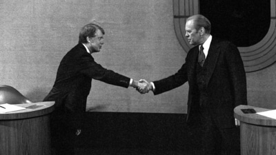 Jimmy Carter, left, and Gerald Ford, right, shake hands before the third presidential debate, Oct. 22, 1976, in Williamsburg, Va. (AP Photo/File) (AP)