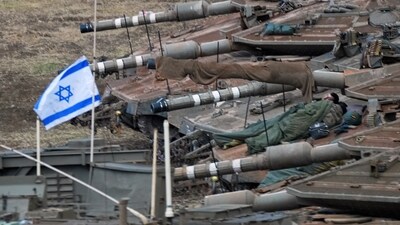 Israeli soldiers sleep on tanks in a staging area in northern Israel near the Israel-Lebanon border, Tuesday, Oct. 1, 2024. (AP Photo/Baz Ratner) (AP)