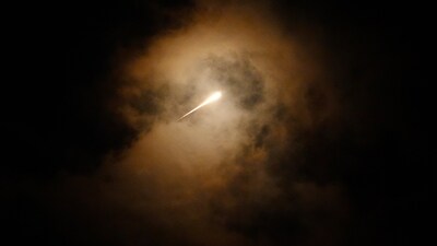 Projectiles fly through the sky in central Israel as a siren sounds a warning of incoming missiles fired from Iran towards Israel. (AP) Projectiles fly through the sky in central Israel as a siren sounds a warning of incoming missiles fired from Iran towards Israel. (AP)
