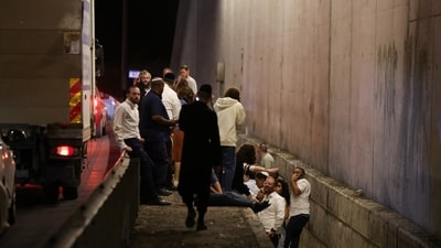 People take shelter during an air raid siren, amid cross-border hostilities between Hezbollah and Israel, in central Israel October 1. (Reuters)