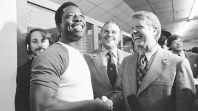 In 1973, Georgia Governor Jimmy Carter and Delaware Governor Sherman Tribbitt greeted baseball legend Hank Aaron of the Atlanta Braves after a game with the Los Angeles Dodgers was canceled due to rain in Atlanta, Georgia. (AP Photo, File) (AP)