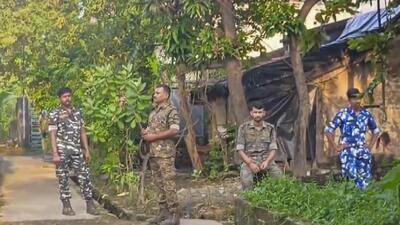 Security personnel stand guard during a raid by NIA on a house belonging to people allegedly linked to Maoists in West Bengal’s North 24 Parganas district on Tuesday. (PTI) Security personnel stand guard during a raid by NIA on a house belonging to people allegedly linked to Maoists in West Bengal’s North 24 Parganas district on Tuesday. (PTI)