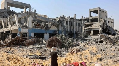 A woman looks around as she salvages items at the damaged UN Relief and Works Agency for Palestine Refugees building complex in western Gaza City's Al-Sinaa. (AFP) A woman looks around as she salvages items at the damaged UN Relief and Works Agency for Palestine Refugees building complex in western Gaza City's Al-Sinaa. (AFP)