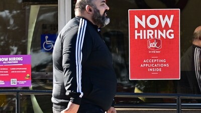 A pedestrian walks past a "Now Hiring" sign posted on a business storefront in San Gabriel, California. August saw job openings increase to 8.04 million, led by construction, amid a declining hiring rate. The labor market remains mixed, prompting potential interest rate adjustments by the Federal Reserve. (AFP) A pedestrian walks past a "Now Hiring" sign posted on a business storefront in San Gabriel, California. August saw job openings increase to 8.04 million, led by construction, amid a declining hiring rate. The labor market remains mixed, prompting potential interest rate adjustments by the Federal Reserve. (AFP)