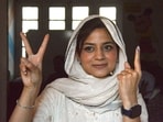 PDP candidate Iltija Mufti shows victory sign and her finger marked with indelible ink after casting her vote at Bejbehara polling station during the first phase of Jammu and Kashmir Assembly elections. 