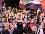 A woman holds a sign showing the face of the Lebanese group Hezbollah's slain leader Hassan Nasrallah with the Persian slogan "Hezbollah is alive", during a rally celebrating after Iran launched a barrage of missiles at Israel in response to the killings of Nasrallah and other Iran-backed militants outside Imam Jaafar Sadiq Mosque in Tehran's Palestine Square on October 1, 2024. A woman holds a sign showing the face of the Lebanese group Hezbollah's slain leader Hassan Nasrallah with the Persian slogan "Hezbollah is alive", during a rally celebrating after Iran launched a barrage of missiles at Israel in response to the killings of Nasrallah and other Iran-backed militants outside Imam Jaafar Sadiq Mosque in Tehran's Palestine Square on October 1, 2024.