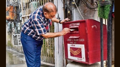 A city resident posts a letter into letter box in Ludhiana on Saturday. (HT Photo) A city resident posts a letter into letter box in Ludhiana on Saturday. (HT Photo)