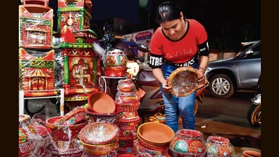 A woman buys earthen pots on the eve of Navratras in Ludhiana on Wednesday. (HT Photo) A woman buys earthen pots on the eve of Navratras in Ludhiana on Wednesday. (HT Photo)