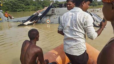 Locals assist in rescue operation after the IAF chopper made an emergency landing in a waterlogged area after developing a snag in Muzaffarpur district of Bihar on Wednesday. (PTI Photo) Locals assist in rescue operation after the IAF chopper made an emergency landing in a waterlogged area after developing a snag in Muzaffarpur district of Bihar on Wednesday. (PTI Photo)