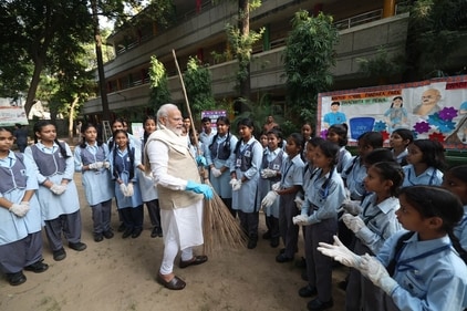 PM Modi interacts with school students during a cleanliness drive to mark the 10th anniversary of Swachhata Bharat campaign. (@narendramodi (X))
