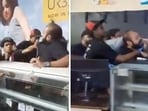 At one point in the video, a few KFC workers grab the man by the neck and keep him in a chokehold as another worker continues to hit him. 