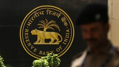 A police officer walks past the Reserve Bank of India (RBI) logo inside its headquarters in Mumbai, India. (Reuters)