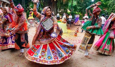 In Ahmedabad, Navratri is synonymous with Garba and Dandiya Raas. The city comes alive as men and women, adorned in vibrant traditional attire like kediyus and ghaghra-choli with mirrorwork In Ahmedabad, Navratri is synonymous with Garba and Dandiya Raas. The city comes alive as men and women, adorned in vibrant traditional attire like kediyus and ghaghra-choli with mirrorwork