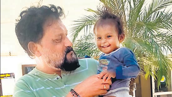 The rescued baby with a crime branch official.