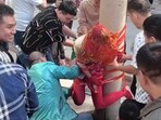 The image shows a bride taped to a pole, a century-old wedding ritual that sparked social media outrage. 
