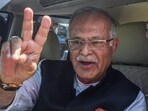 Jammu and Kashmir Congress unit chief Tariq Hameed Karra shows a victory sign after filing nomination papers from the Central Shalteng. 