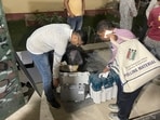 Polling officials with EVMs and other polling materials. Polling officials with EVMs and other polling materials.