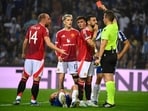 Manchester United's Portuguese midfielder #08 Bruno Fernandes (2R) remonstrates with German referee Tobias Stieler as he is presented a red card for fouling FC Porto's Argentine defender